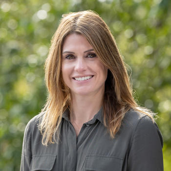 Dr Jennifer Beer looking at a camera, smiling