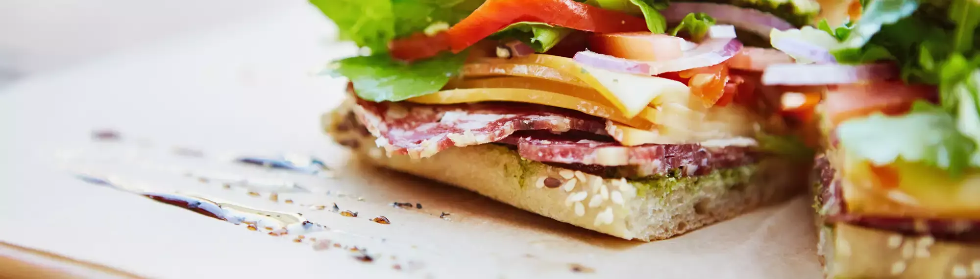 Close up photo of a focaccia cut in two showing various ingredients.