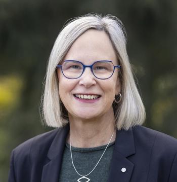 Marg Allan looking at a camera, smiling